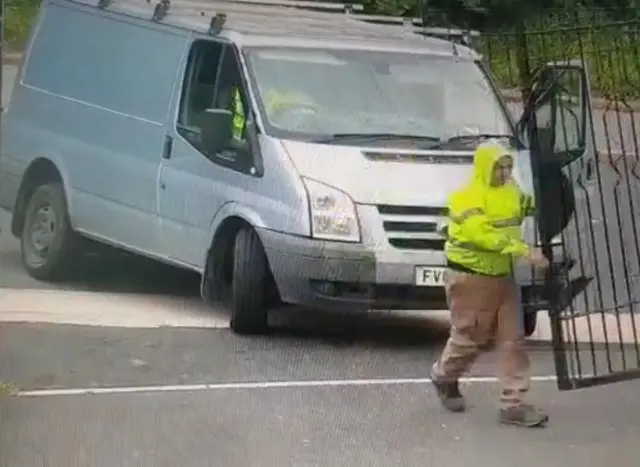 A man opening a gate