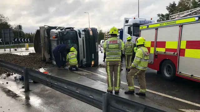 A tipper truck on its side