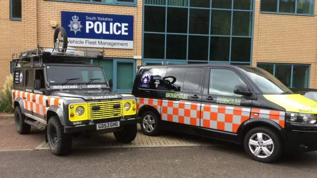 The current Land Rover and a van