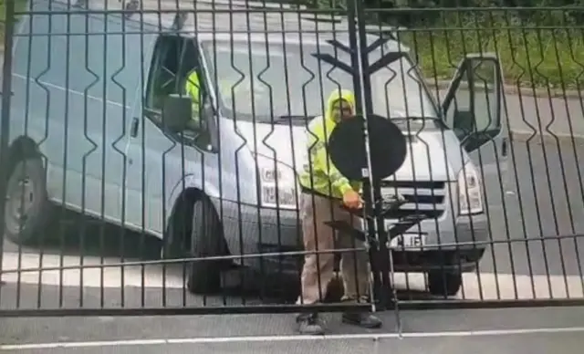 A man opening a gate