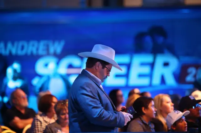 Supporters of Conservative leader Andrew Scheer react to the latest results during an election night rally in Regina, Saskatchewan on October 21, 2019.