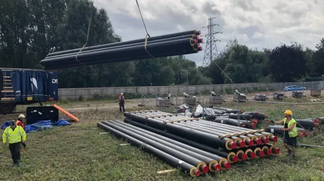 Some of the pipes being lifted into position