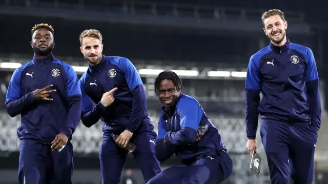 Luton Town players Kazenga LuaLua, Andrew Shinnie, Pelly-Ruddock Mpanzu and Corey Panter pose for a photo