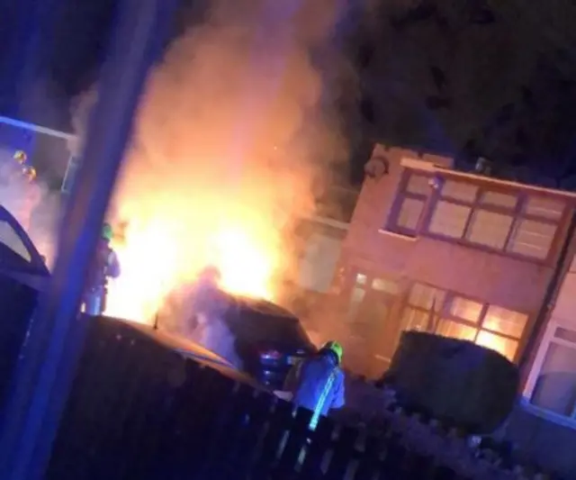 Cars on fire outside house