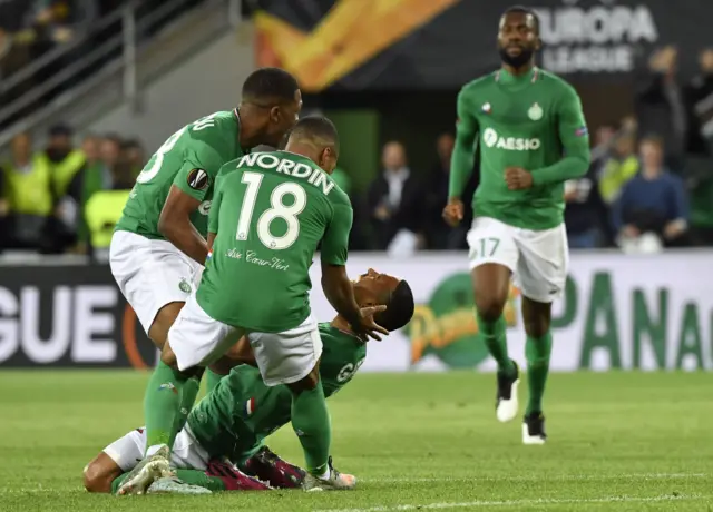 Brazilian defender Gabriel Silva (down) is congratuled by teammates