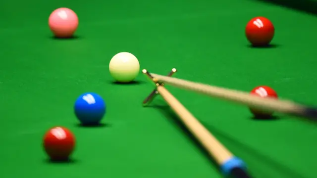 A person playing snooker