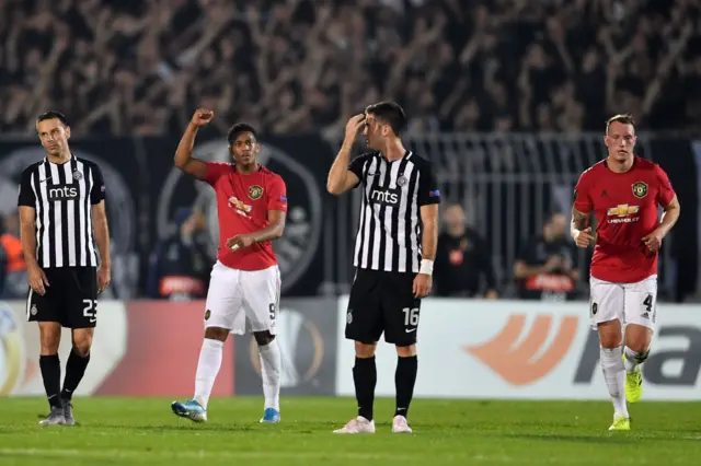 Anthony Martial (2L) celebrates after taking a penalty and scoring his team's first goal during the UEFA Europa league group L football match between Partizan Belgrade and Manchester United