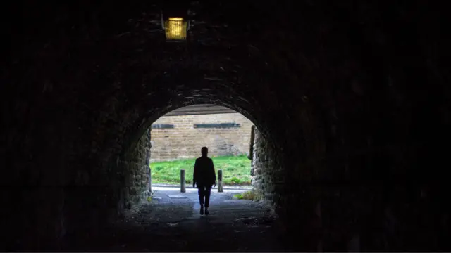 A person walking in a tunnel