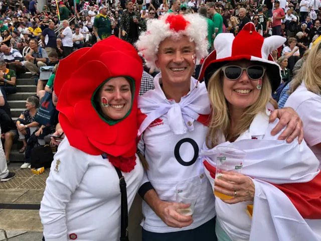 A family all wearing red and white hats and wigs