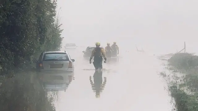 Firefighters in flood water