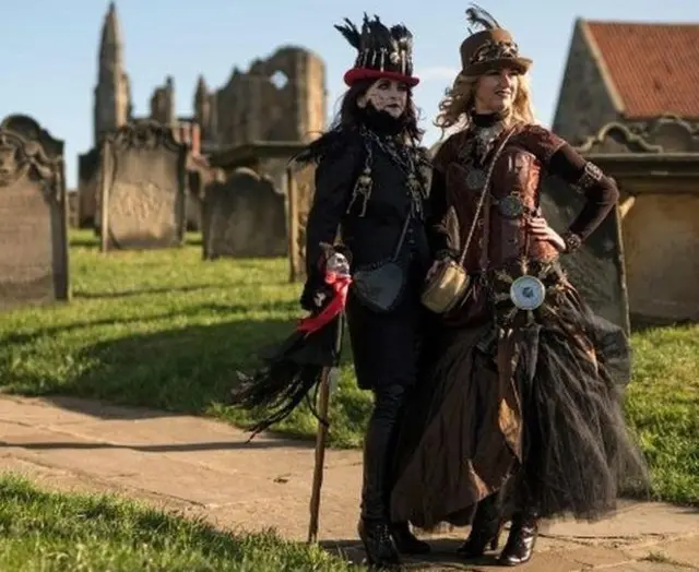 Two costumed Goths in front of  Whitby Abbey