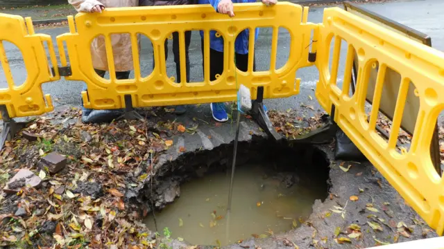 Hole in road near school