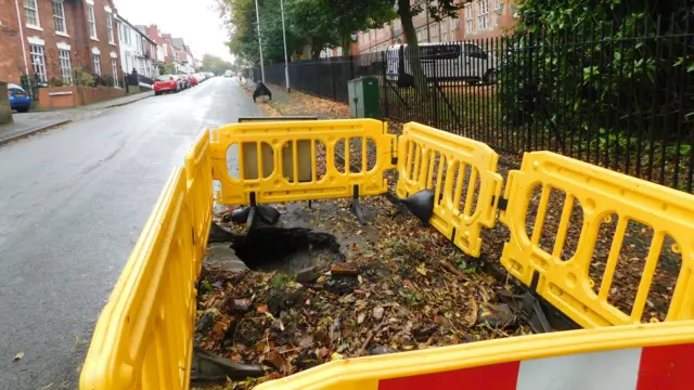 Hole in road near school