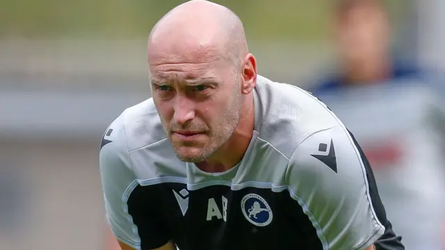 Millwall coach Adam Barrett on the sidelines