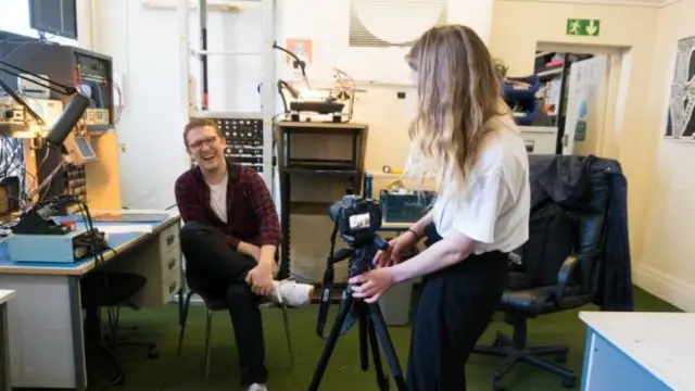 A young person uses a camera