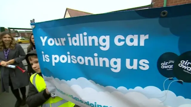 Pupils holding banner