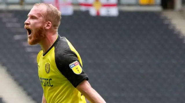 Liam Boyce celebrating scoring for Burton against MK Dons