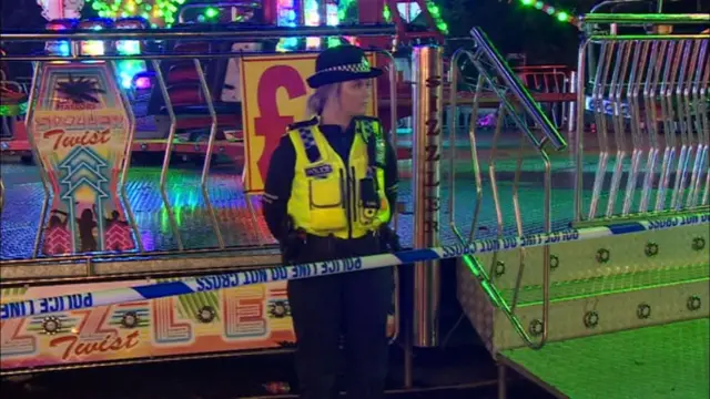 A police officer in front of the ride