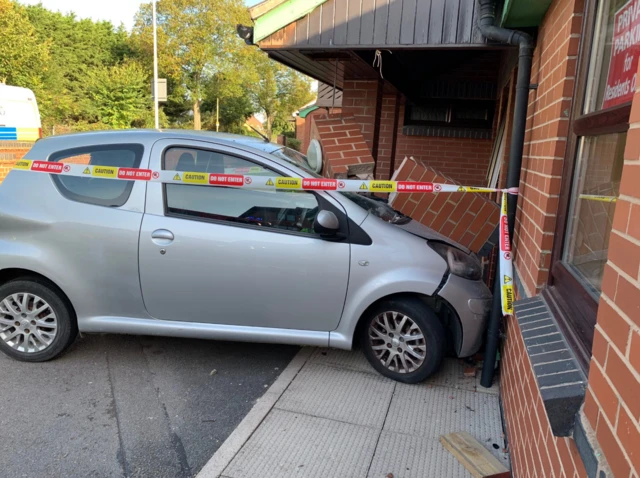 Car with parts of building on it