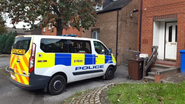 A police van outside a house