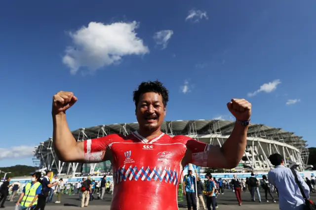 A fan with a Russian jersey painted on his torso