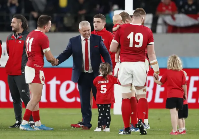 Warren Gatland with the Wales players on the pitch