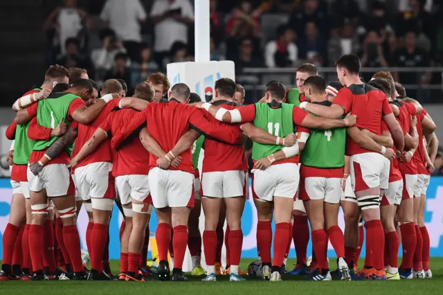 Wales players in a huddle during their pre-match warm-up