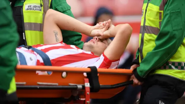 Ryan Shawcross being stretchered off during the game