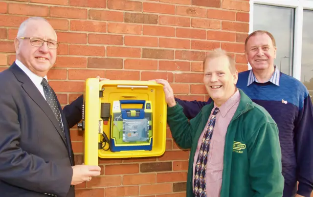 Freemasons and LIVES staff with defibrillator