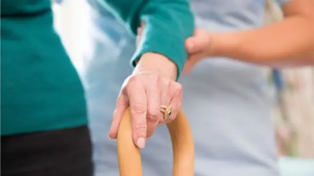 Older patient being supported