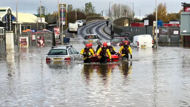 Firefighters using a boat