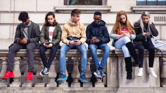 Students sitting on a wall