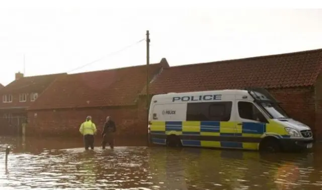 Police van in flood water