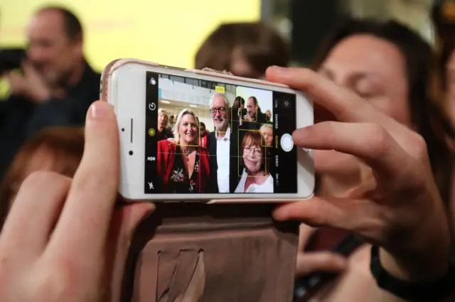 Jeremy Corbyn posing for a smartphone photo