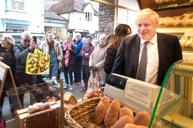 Boris Johnson in Burns the Bread bakery, during a walkabout, in the Wells constituency, Somerset