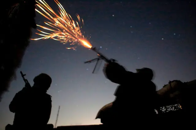 Ukrainian troops fire at a military drone