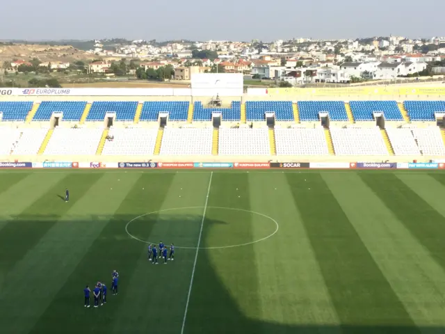 The Scotland players gather on the pitch in Nicosia