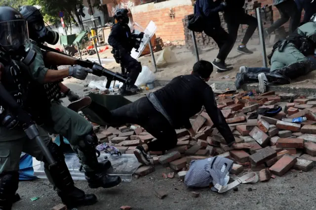 Riot police arrest a protester at the Polytechnic University campus in Hong Kong