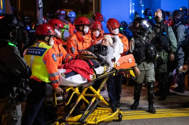 Injured people are taken away from Hong Kong Polytechnic University