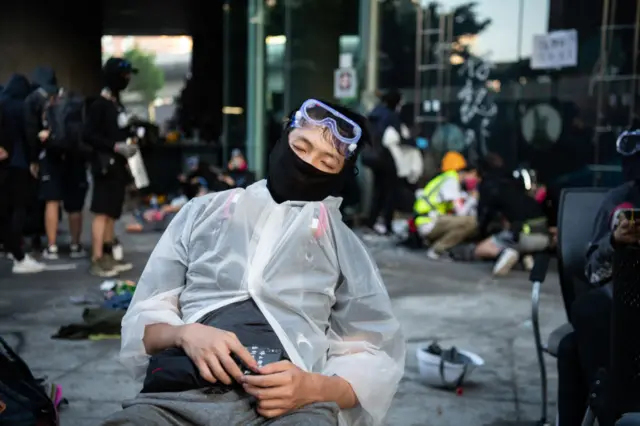 An anti-government protester sleeps after clashes with police at Hong Kong Polytechnic University on November 18, 2019 in Hong Kong, China.