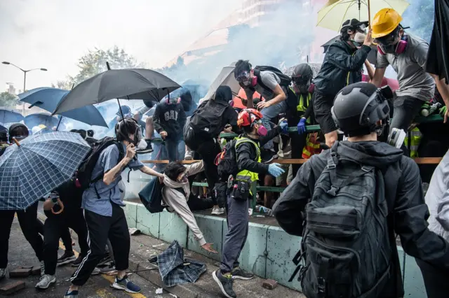 Anti-government protesters flee from the police at Hong Kong Polytechnic Universitys campus on November 18, 2019 in Hong Kong