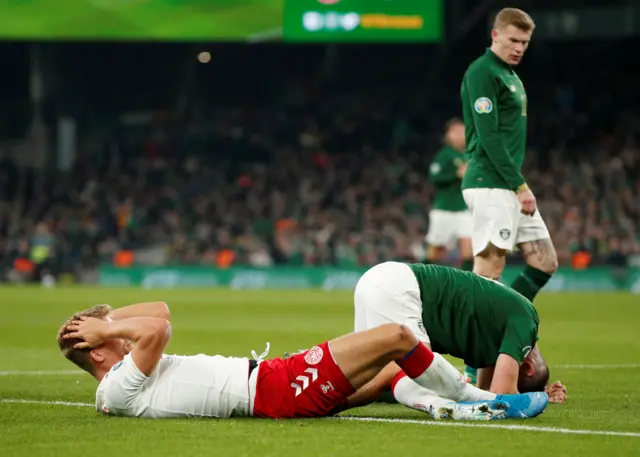 Denmark and Ireland players on the ground