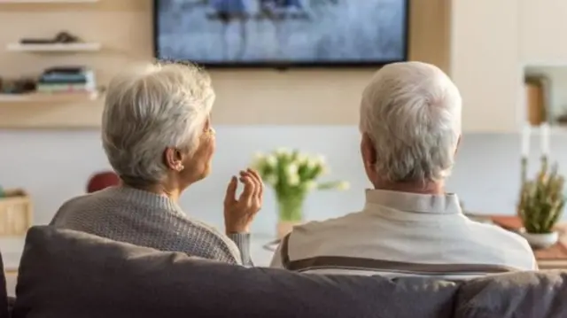 Elderly couple watching TV