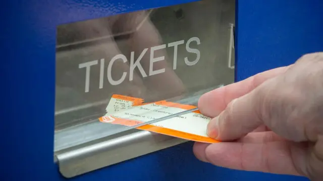 A ticket it pulled from a ticket machine dispensing tray in close-up