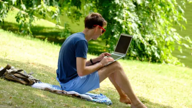 Man on laptop in park