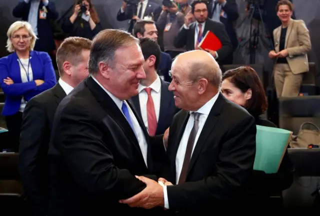 Secretary of State Mike Pompeo shakes hands with French Foreign Minister Jean-Yves Le Drian during a NATO foreign ministers meeting at the Alliance headquarters in Brussels