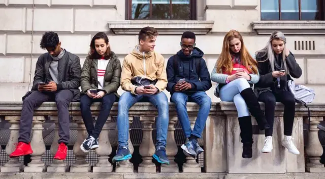 Students sitting on a wall