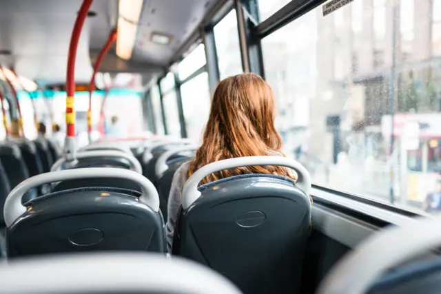 Woman sitting on a bus