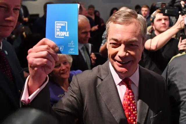 Nigel Farage holds the Brexit Party's "contract with the people" document