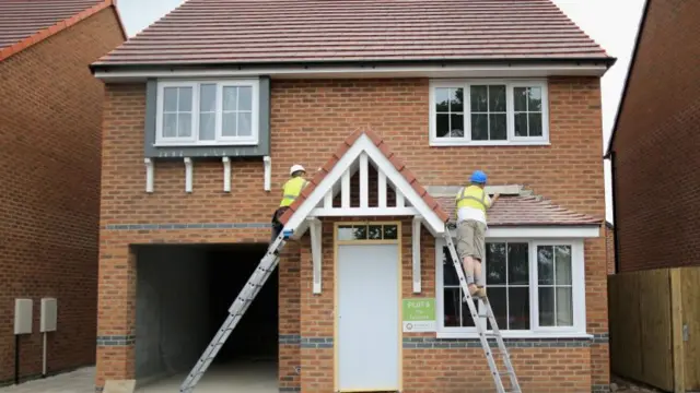 Construction workers build new houses